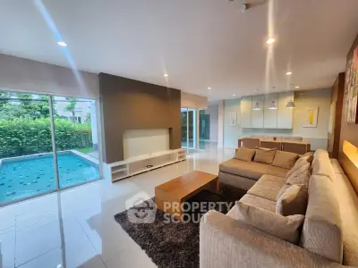 Spacious modern living room with pool view and elegant furnishings