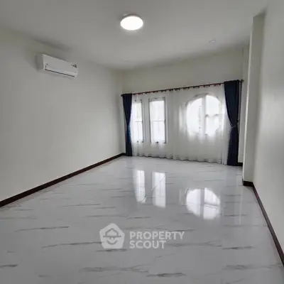 Spacious empty room with elegant curtains and air conditioning, perfect for customization.