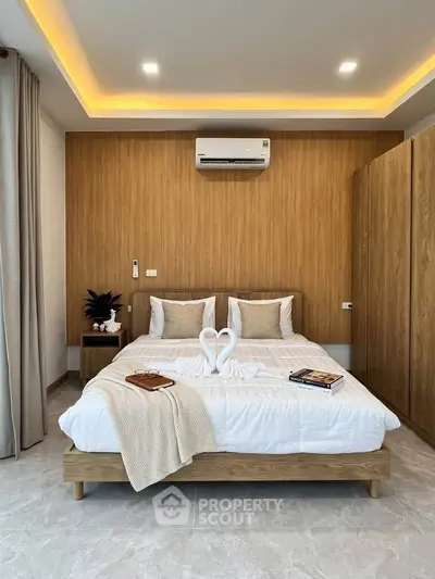 Modern bedroom with elegant wood paneling and cozy decor