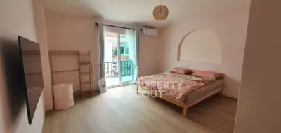 Spacious bedroom with balcony access and modern decor