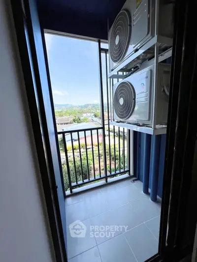 Compact balcony with air conditioning units and scenic view