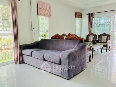 Spacious living room with elegant furniture and large windows for natural light.