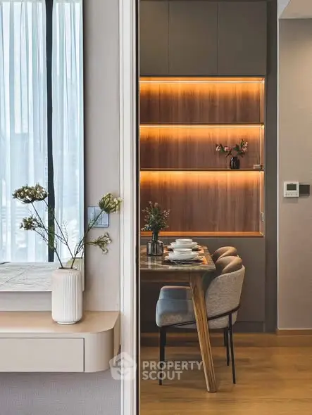 Modern dining area with elegant wooden table and ambient lighting