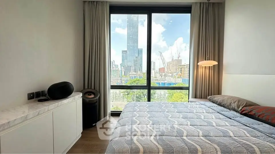 Modern bedroom with stunning city view through large window, featuring stylish decor and comfortable bedding.