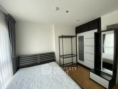 Spacious and well-lit bedroom with large windows, modern furnishings, and ample storage space, perfect for a restful retreat.