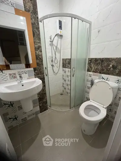 Modern bathroom with shower enclosure and stylish tile design