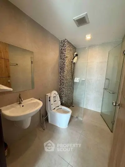 Modern bathroom with glass shower and sleek fixtures