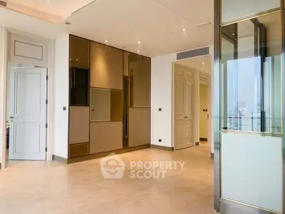 Luxurious modern living room with elegant finishes and city view, featuring floor-to-ceiling windows and sleek design.