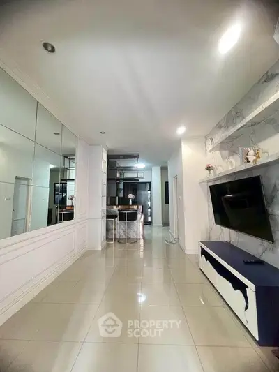 Spacious modern living room with sleek design and built-in TV unit, perfect for contemporary living.