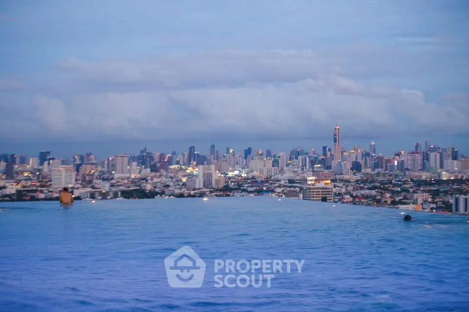 Stunning city skyline view from rooftop infinity pool at dusk, perfect for luxury urban living.