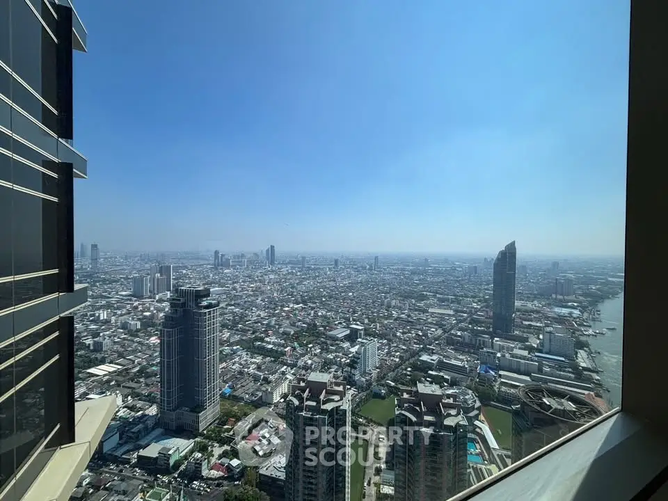 Stunning high-rise cityscape view from a modern apartment balcony, showcasing urban skyline and river.