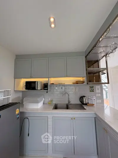 Modern kitchen with sleek cabinetry and built-in appliances in a stylish apartment.
