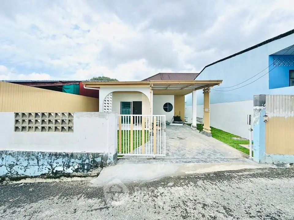 Charming single-story home with gated entrance and spacious driveway, perfect for family living.
