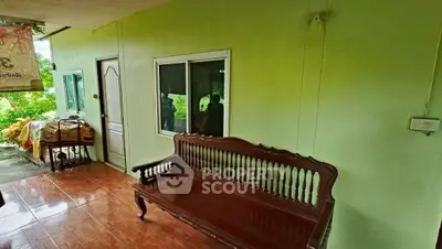 Charming outdoor seating area with wooden bench and lush greenery view.