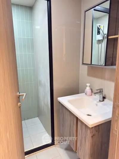 Modern bathroom with sleek sink and glass shower enclosure