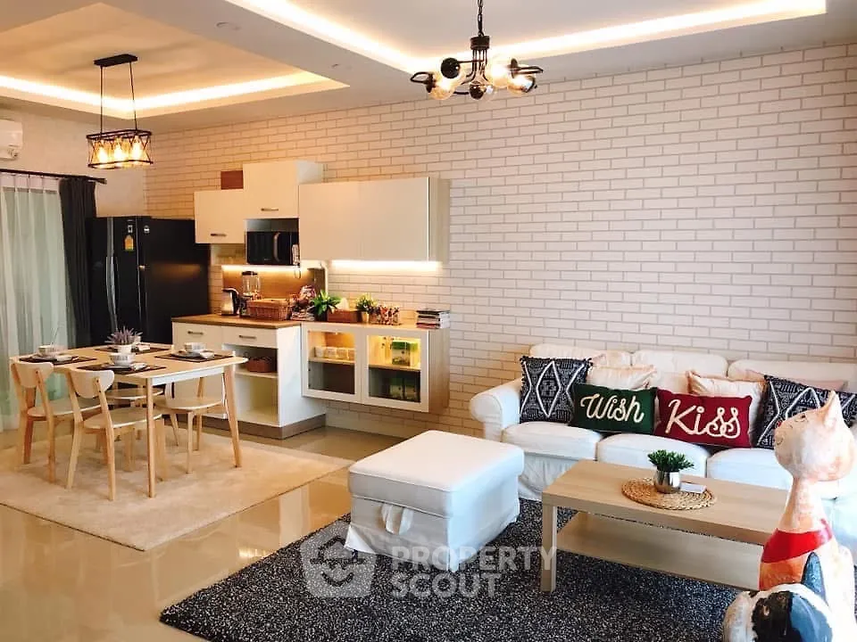 Modern open-plan living room and kitchen with stylish decor and cozy ambiance.