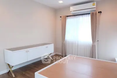 Modern bedroom with sleek furniture and air conditioning, perfect for comfort and style.