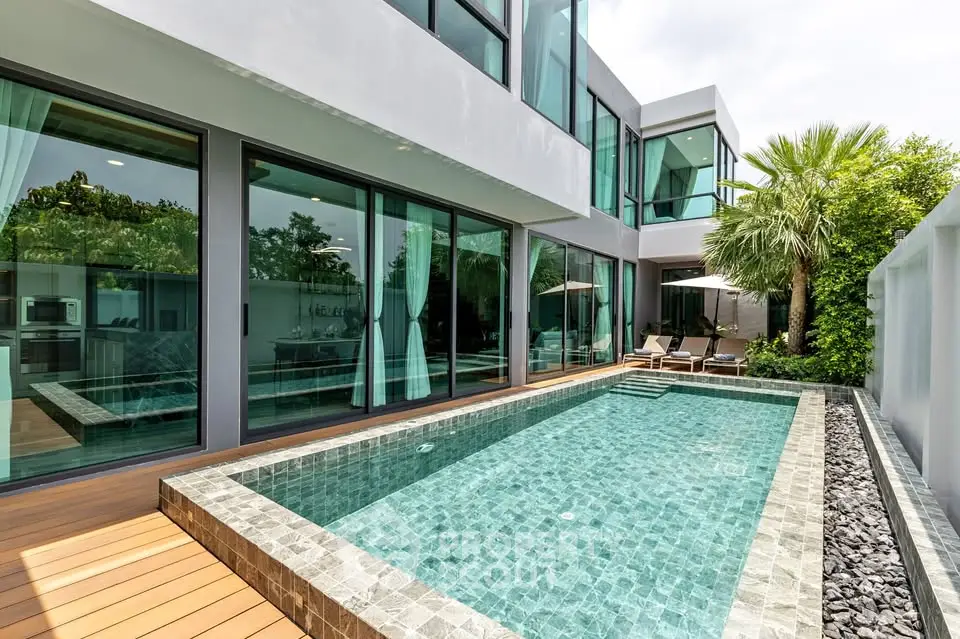 Luxurious modern villa with private pool and lush greenery, perfect for relaxation and entertainment.