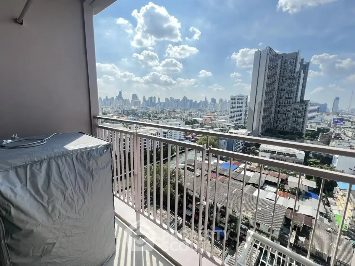 Stunning cityscape view from a high-rise balcony with clear blue skies.