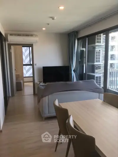 Modern living room with sleek furniture and large windows in a stylish apartment.