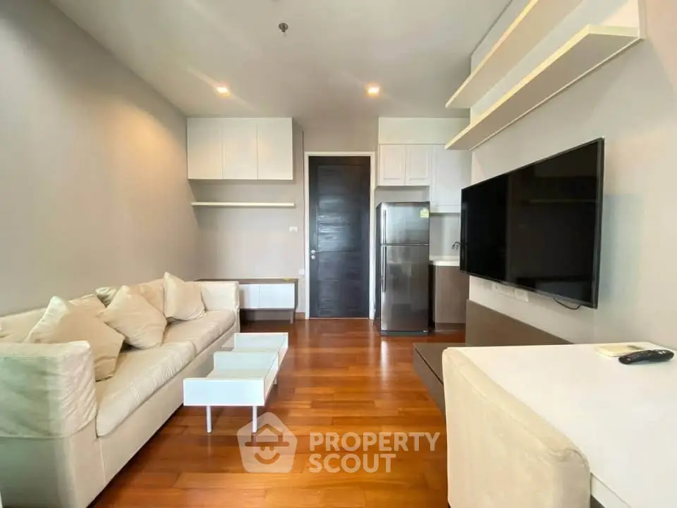 Modern living room with sleek furniture and mounted TV in a stylish apartment.