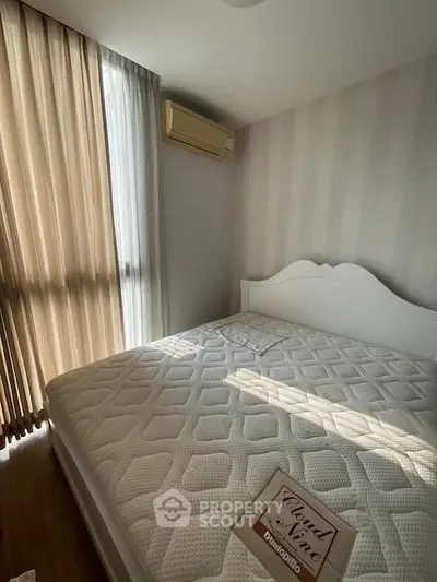 Cozy bedroom with natural light and elegant decor, featuring a comfortable bed and stylish curtains.