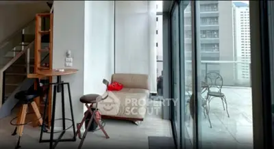 Modern apartment with stylish interior and spacious balcony offering city views.