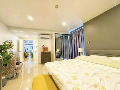 Spacious modern bedroom with elegant decor and ample natural light