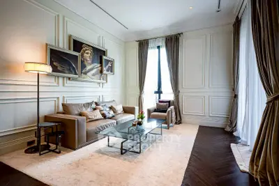 Luxurious living room with elegant decor and large windows in a high-end apartment.