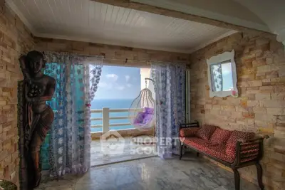 Stunning ocean view from a cozy balcony with elegant decor and seating area.