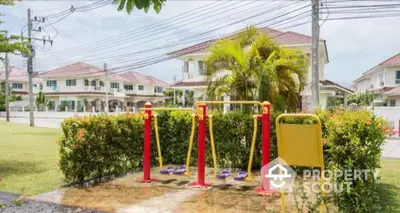 Charming suburban neighborhood with outdoor gym equipment and lush greenery.