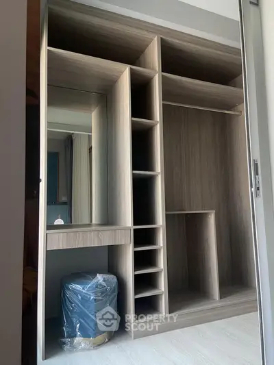 Spacious modern walk-in closet with sleek wooden finish and ample storage space.
