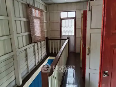 Charming rustic hallway with wooden paneling and natural light