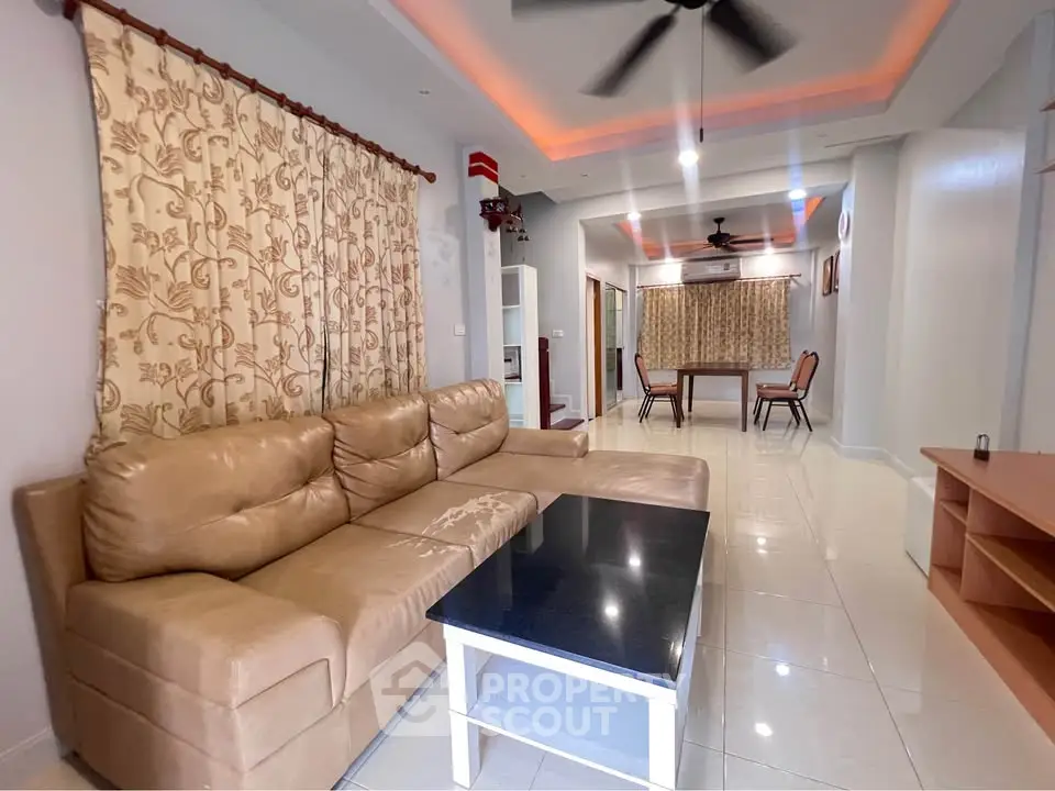 Spacious living room with elegant lighting and cozy seating area
