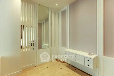 Modern hallway with sleek storage and mirrored wall design
