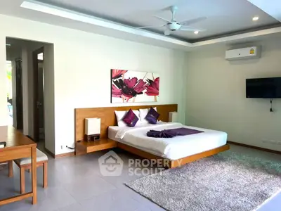Spacious modern bedroom with stylish decor and cozy ambiance
