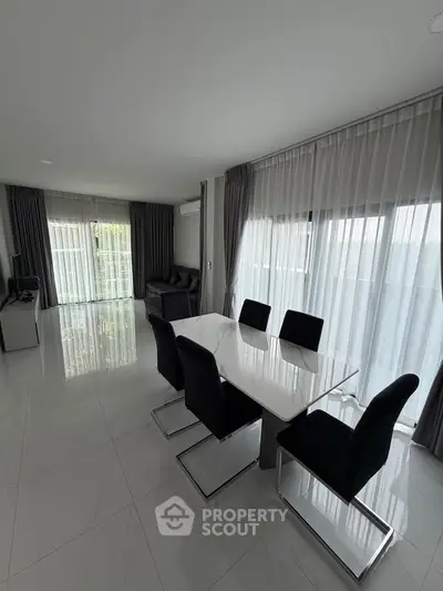 Spacious modern living room with dining area and large windows