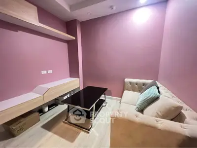 Cozy living room with pink walls, modern furniture, and stylish decor