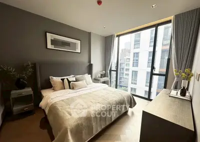 Modern bedroom with large window and stylish decor in urban apartment