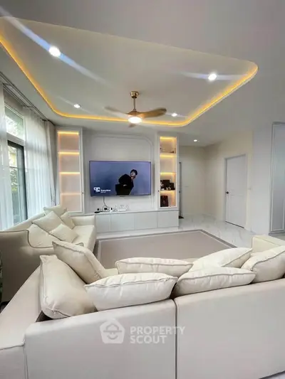 Luxurious living room with modern ceiling lights and cozy beige sofa, perfect for relaxation and entertainment.