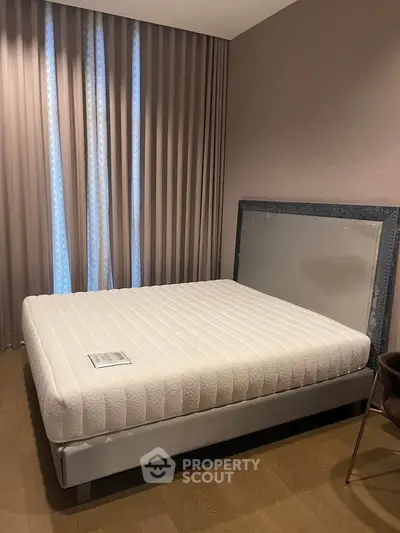 Modern bedroom with stylish bed and elegant curtains, showcasing a cozy and inviting atmosphere.