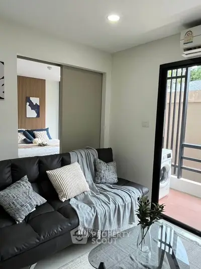 Modern living room with cozy sofa and balcony view