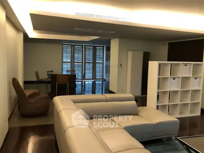 Spacious modern living room with elegant furniture and ample natural light.