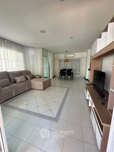 Spacious living room with modern decor and large windows for natural light.