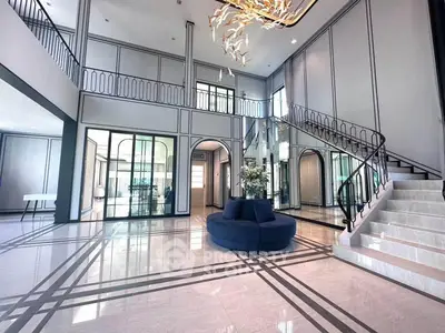 Luxurious modern living room with high ceilings and elegant staircase
