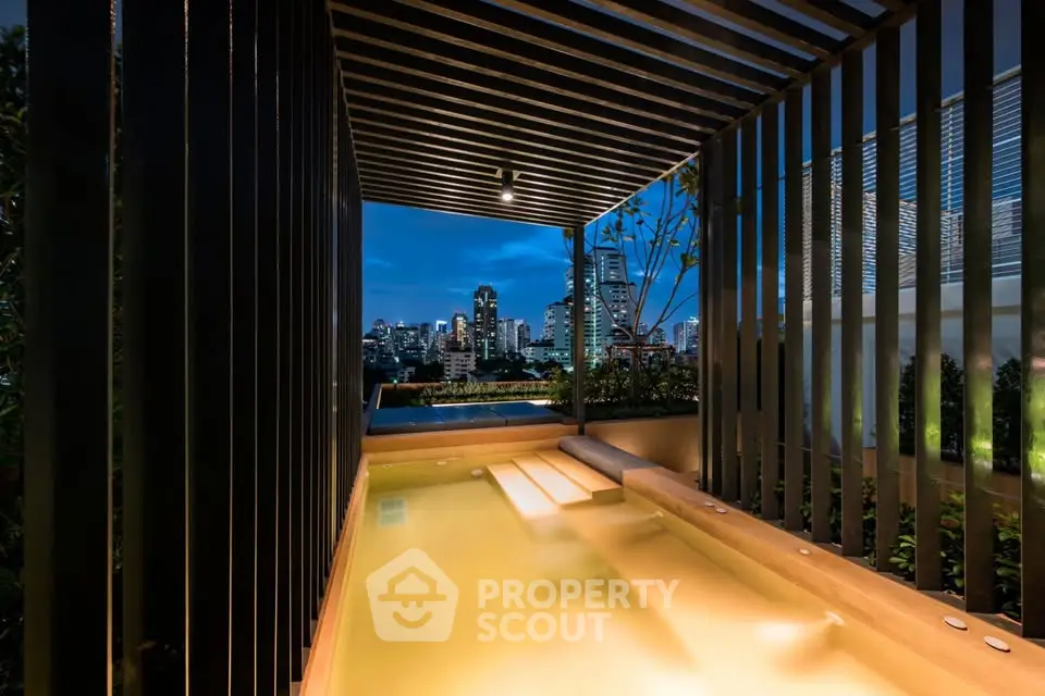 Luxurious rooftop pool with stunning city skyline view at night