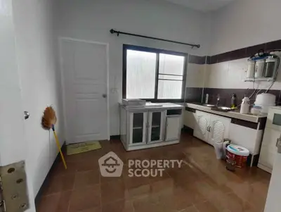 Spacious kitchen with ample natural light and modern fixtures.