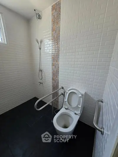 Modern bathroom with accessible features and sleek tile design.