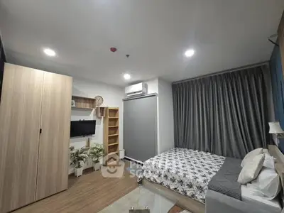 Modern bedroom with stylish decor, featuring a cozy bed, wooden wardrobe, and elegant lighting.