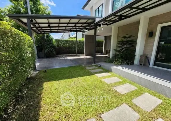 Charming modern home with lush garden and covered patio, perfect for outdoor relaxation.